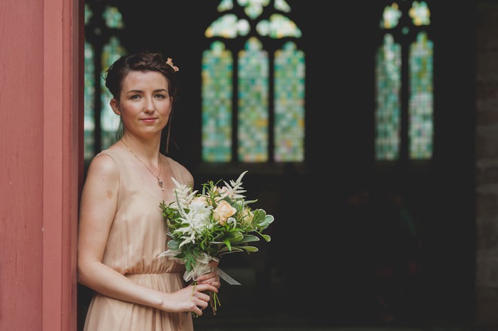 bridesmaid in a peach dress with peach flowers